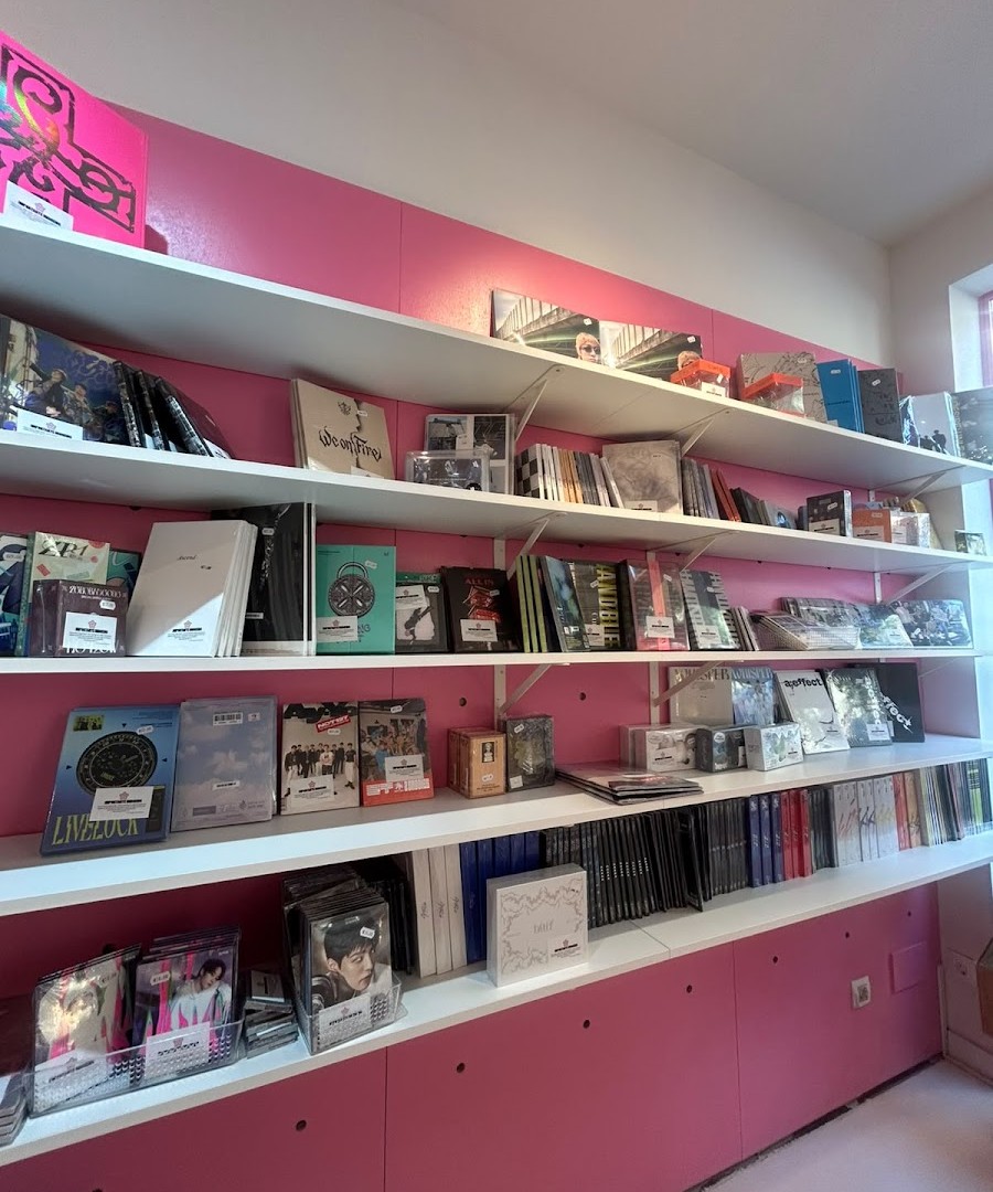 Shelves with official K-pop albums at Momo Store Madrid
