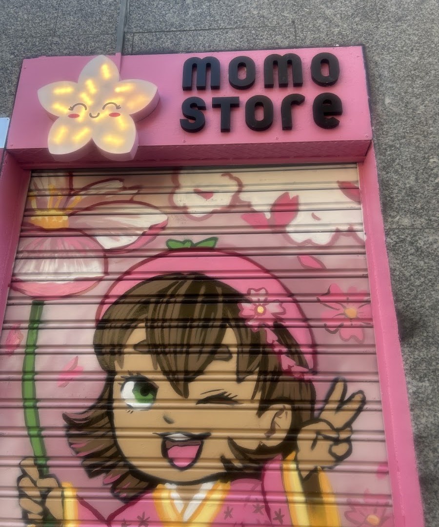 Momo Store illuminated sign at the entrance of the Madrid shop