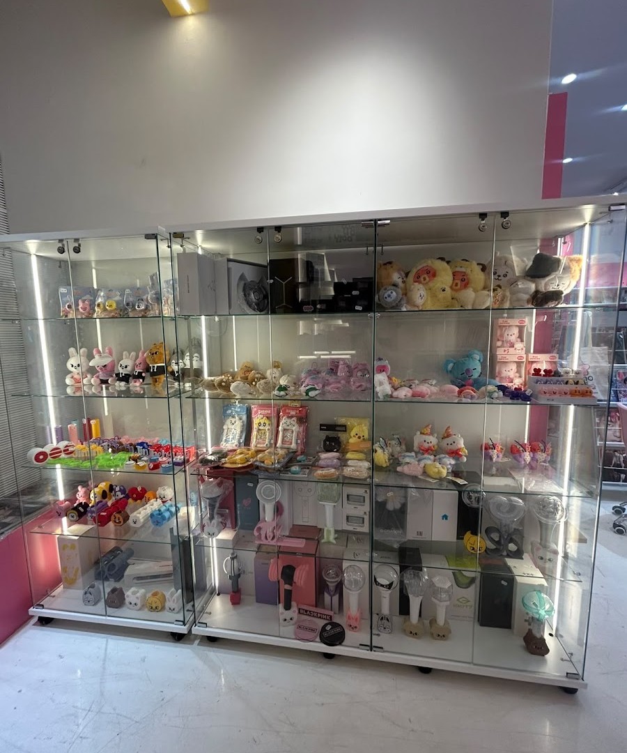 Display case with kawaii plushies and official lightsticks at Momo Store Madrid